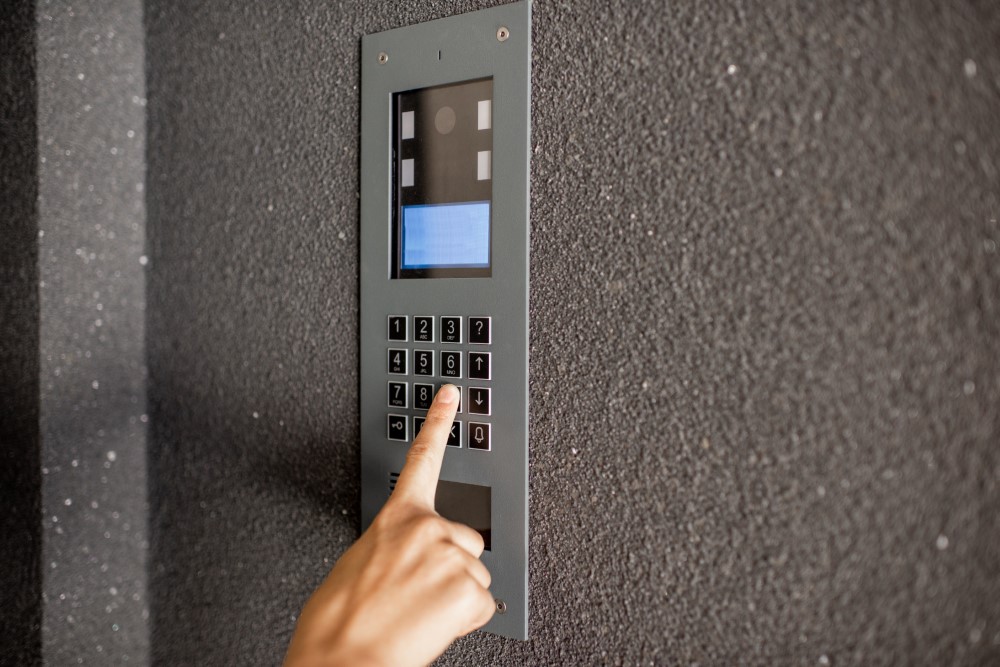 Close Up Of Intercome Keyboard Of Residential Building With Finger Entering Code